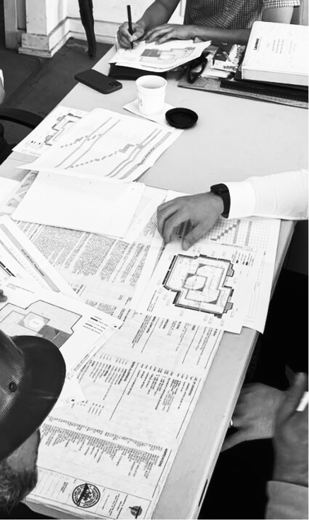 Verado team looking over blueprints of apartment buildings